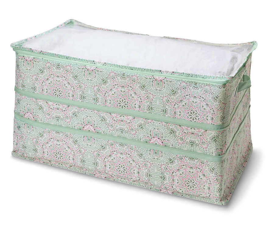 On voit un espace de rangement Jumbo avec couvercle, motif vert et détails roses.