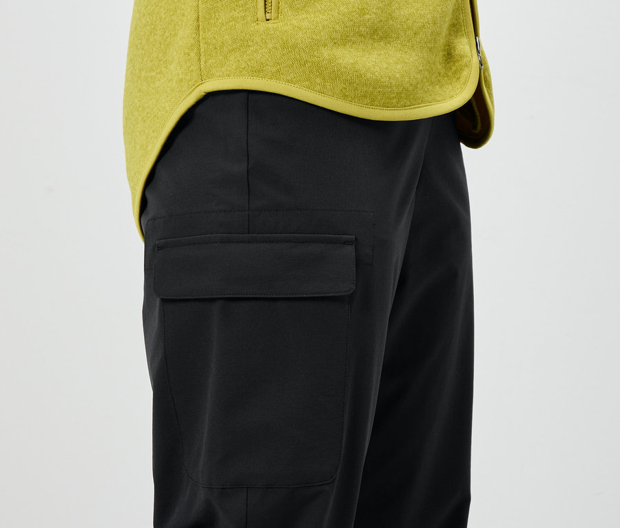 Pantalon noir avec poche et veste jaune.