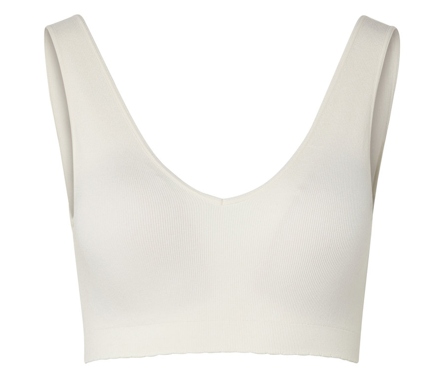 Un haut de soutien-gorge de sport côtelé crème avec un col en V est visible sur un fond blanc.