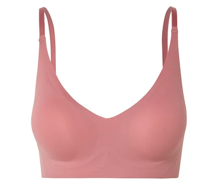 Gros plan d'un soutien-gorge rose à col en V avec bretelles réglables.