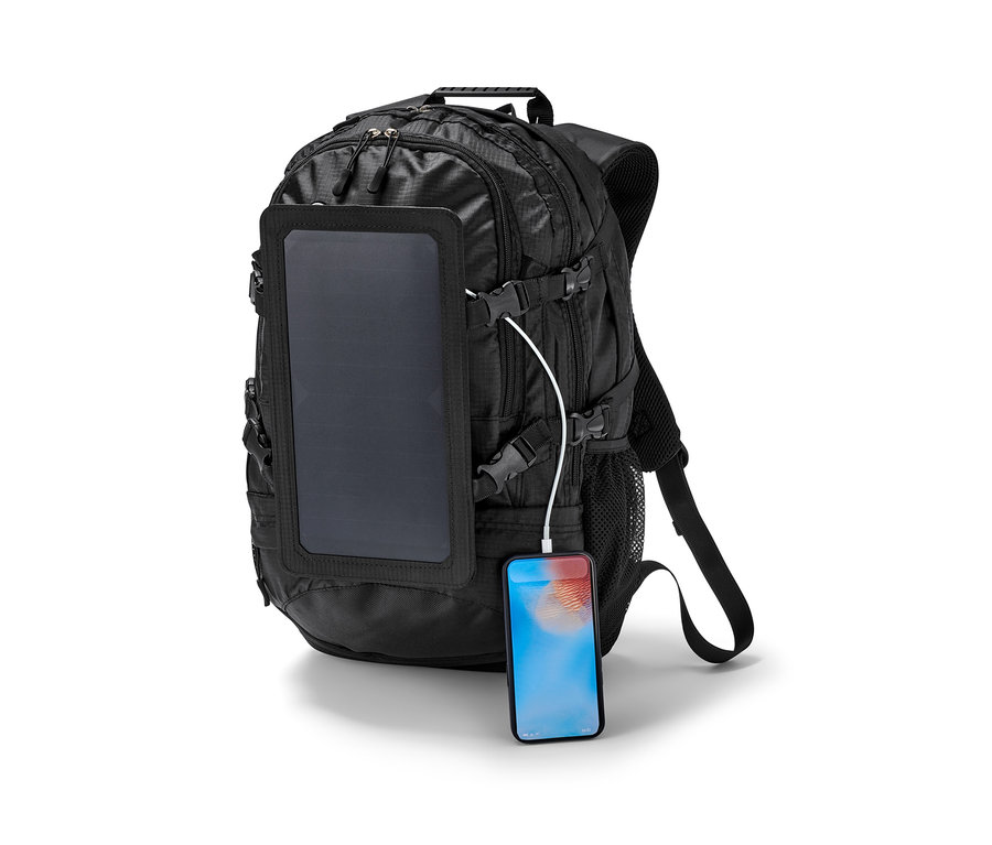 Sac à dos solaire noir avec panneau et téléphone en charge.