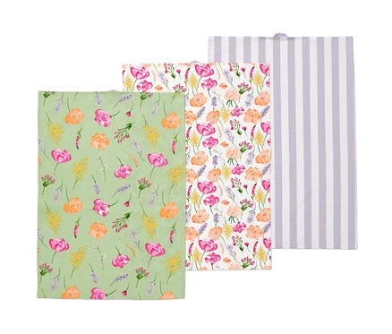 Trois torchons : un vert à motif floral, un à fleurs et un blanc à rayures violettes.
