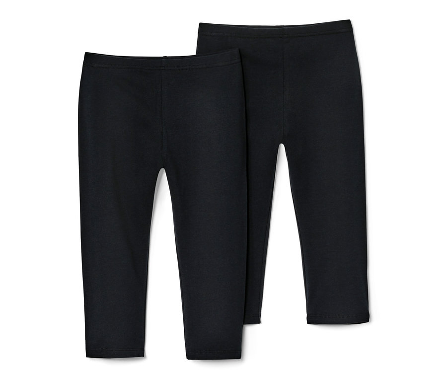 Deux leggins 3/4 pour enfant de couleur noire sont posés côte à côte sur un fond blanc.