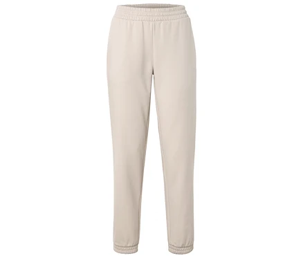 Pantalon de jogging beige avec taille et chevilles élastiquées.