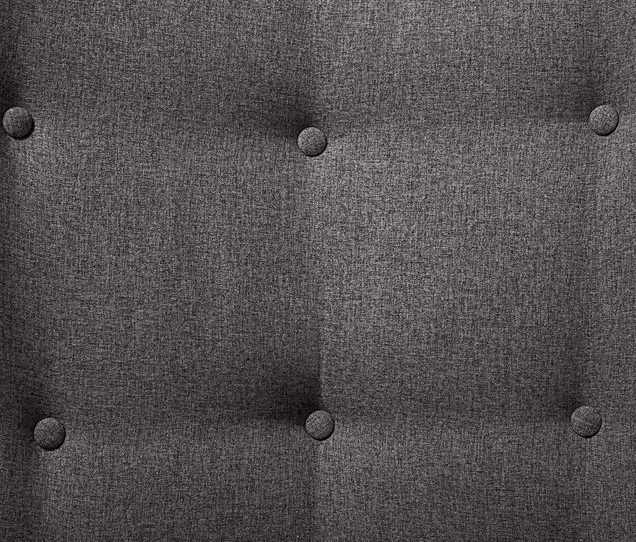 Gros plan sur le détail d'un fauteuil individuel gris foncé avec repose-pieds et boutons.