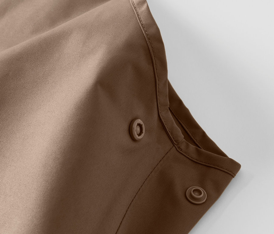 Gros plan sur un pantalon de pluie pour enfant avec boutons-pression.