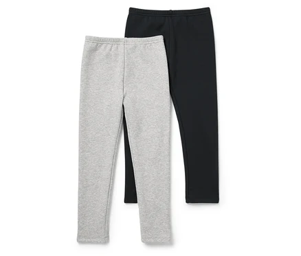 Deux leggings, un gris et un noir, sont placés côte à côte sur un fond blanc.