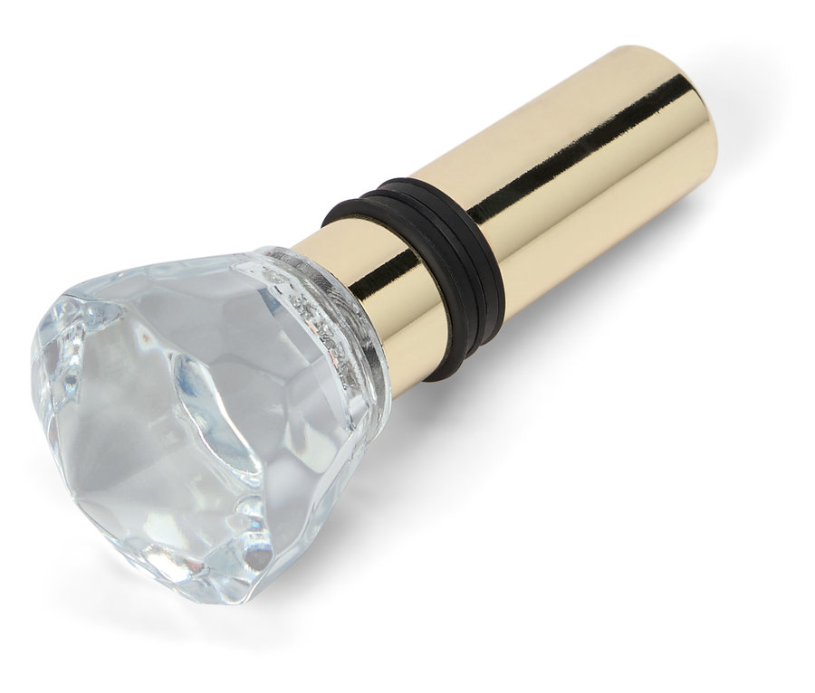 Bouchon de bouteille avec ornement en verre en forme de diamant et base en métal doré.