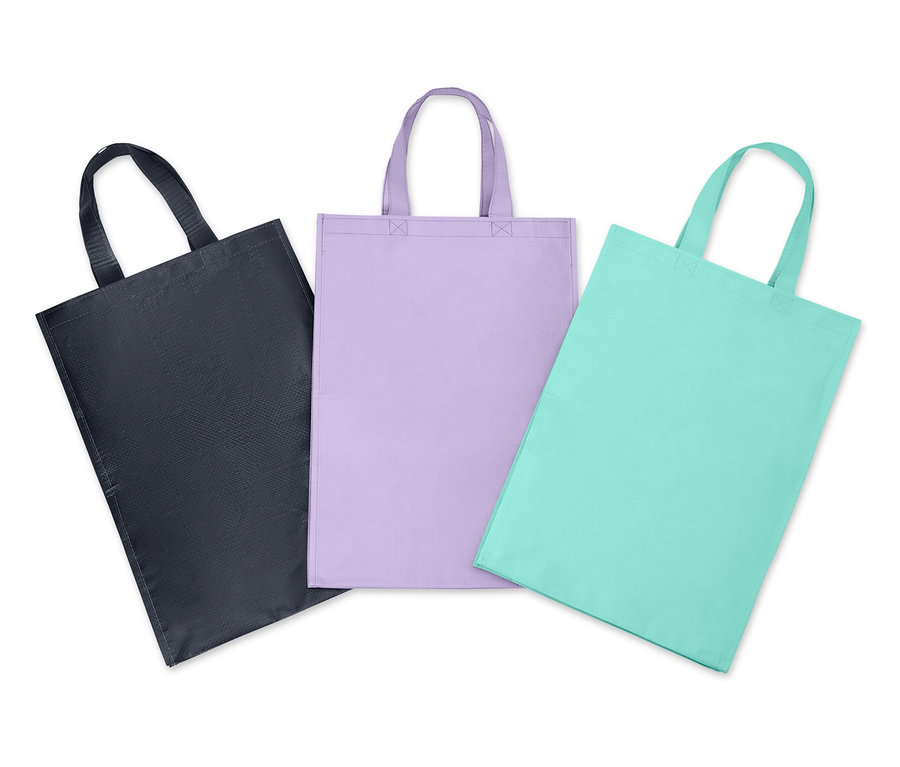 Trois sacs en tissu avec poignées en noir, lilas et turquoise.
