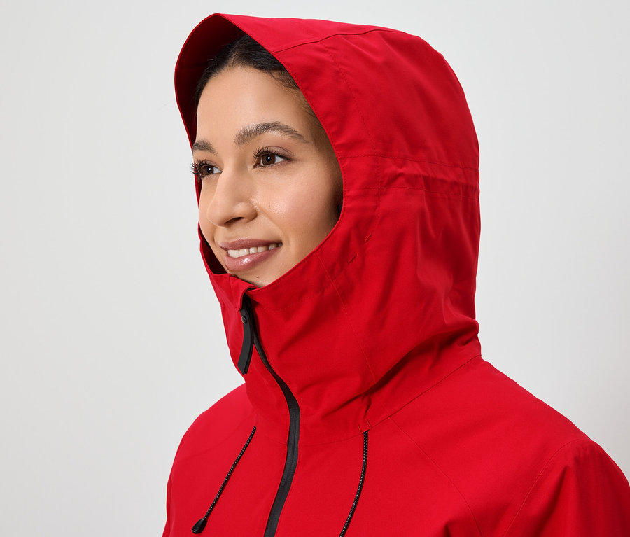 Portrait d'une femme portant une veste rouge à capuche.