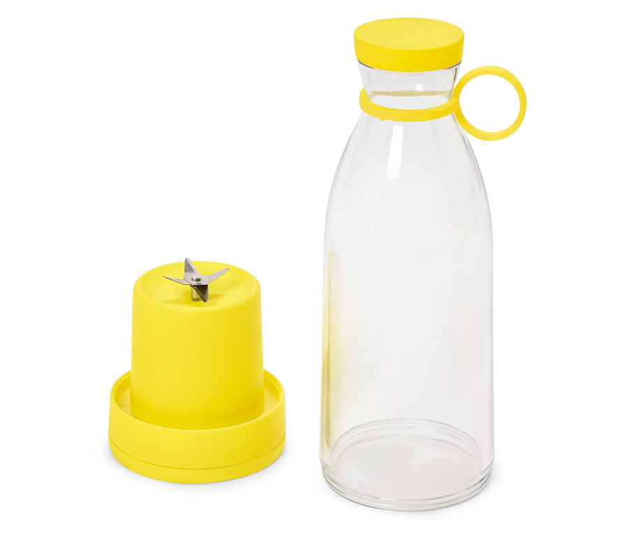 Mélangeur à smoothie jaune avec lame et bouteille.