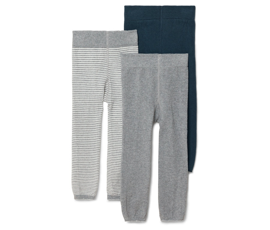 Trois collants pour enfants, un gris à rayures, un gris uni et un bleu marine, sont présentés côte à côte.