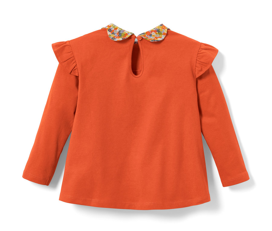T-shirt à manches longues orange pour tout-petits avec un col à fleurs.
