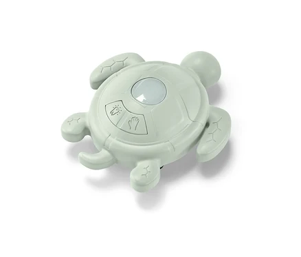Un minuteur vert en forme de tortue pour se laver les mains et se brosser les dents.