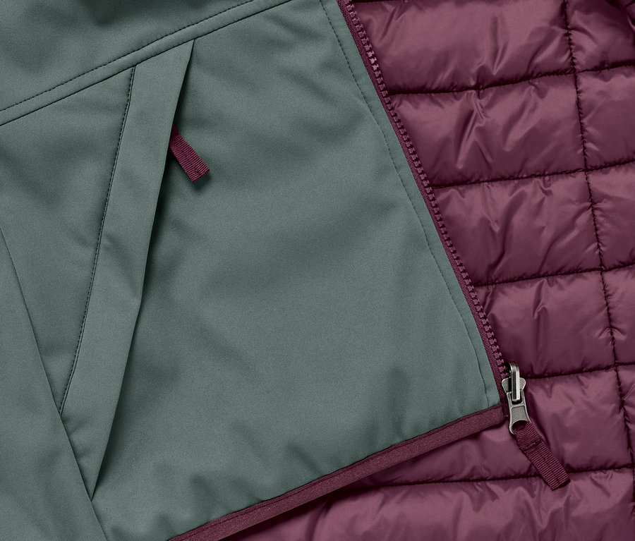 Détail d'une veste matelassée et softshell 2 en 1 pour enfant avec fermeture éclair et poche.