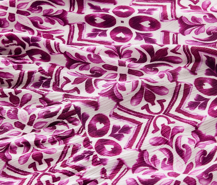 Gros plan d'une robe tissée imprimée avec un motif violet.