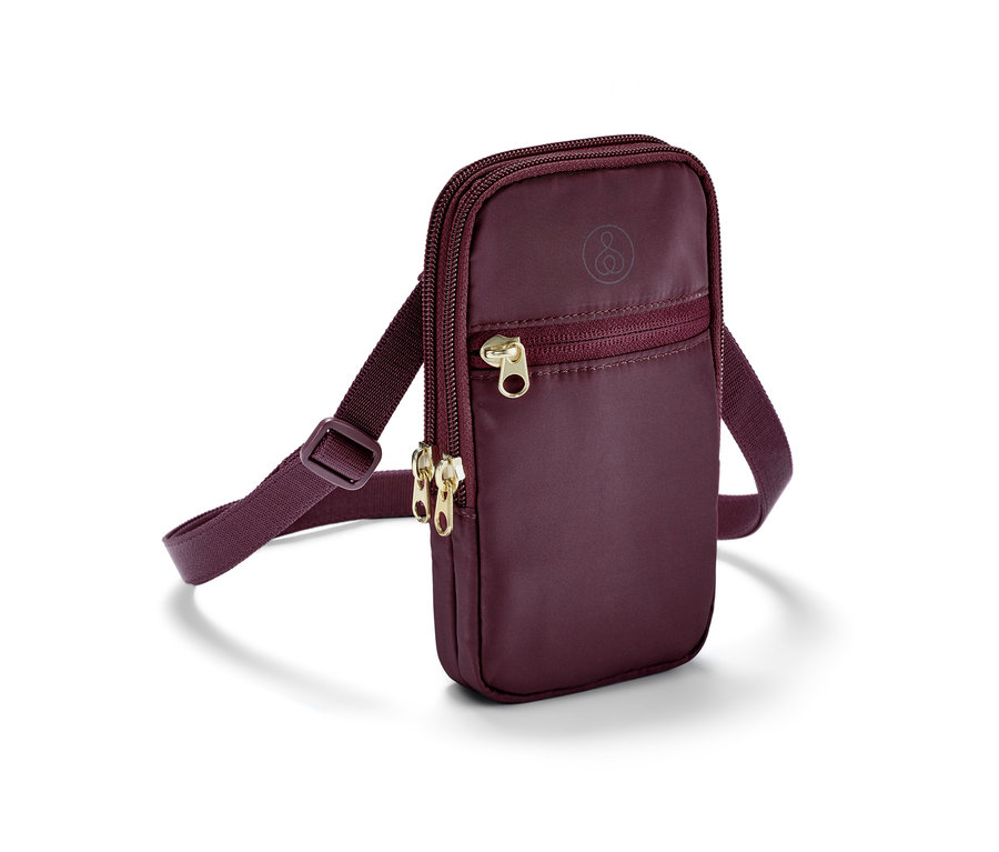 Un sac à bandoulière violet avec des fermetures éclair dorées.