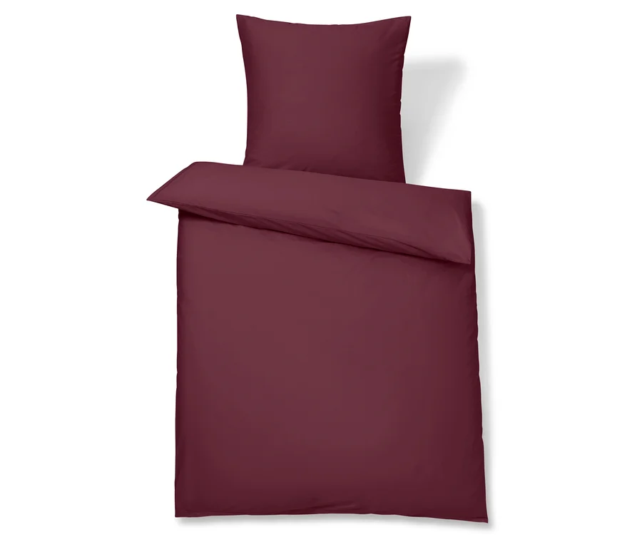 Linge de lit bordeaux avec taie d'oreiller.