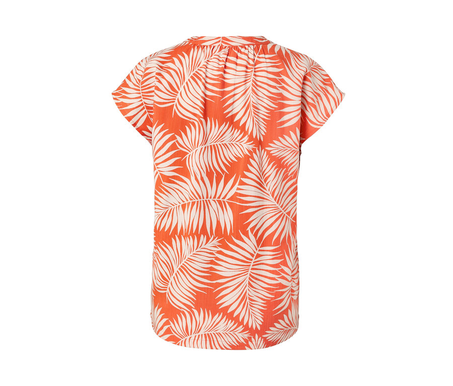 Chemisier imprimé à manches courtes orange avec motif de feuilles.