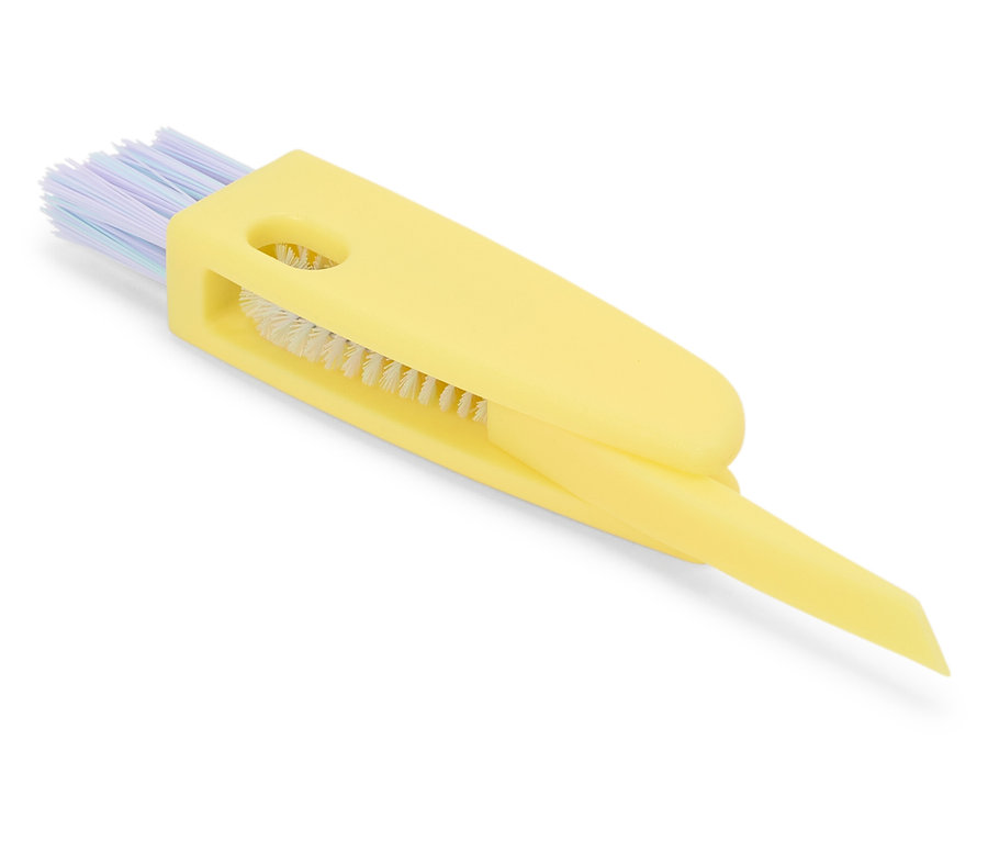 Brosse de détail jaune avec poils et grattoir.