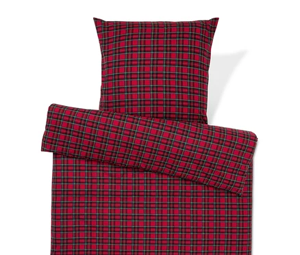 Linge de lit à carreaux rouges avec oreiller.