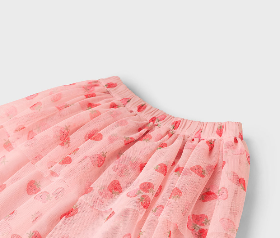 Gros plan d'une jupe en tulle rose avec un motif de fraises.