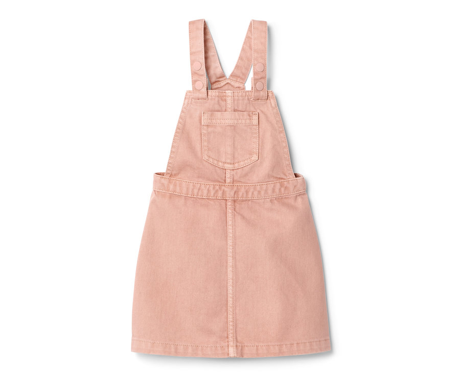 Robe-salopette rose pour enfant sur fond blanc.