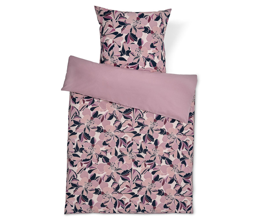 Ensemble de literie avec motif floral et taie d'oreiller unie.