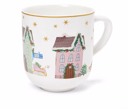 Tasse blanche avec des illustrations de maisons de Noël et d'étoiles dorées.