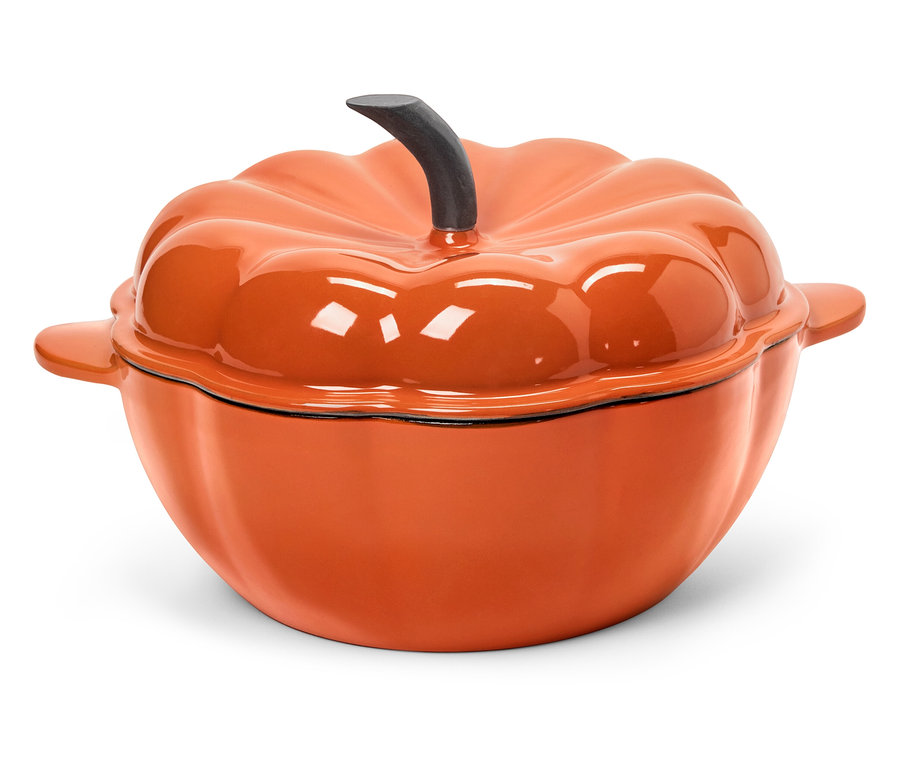 Une cocotte orange avec un couvercle en forme de citrouille sur un fond blanc.