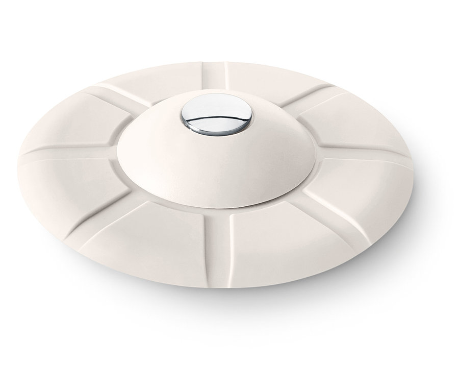 Objet rond crème avec un dessus convexe et un bouton argenté au centre.