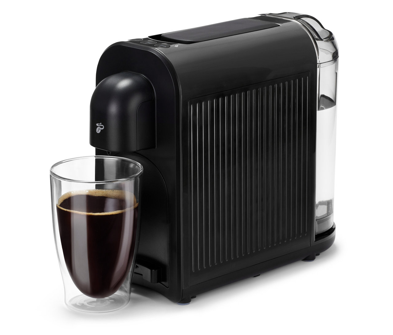 Une machine à café noire Cafissimo now black à côté d'un verre de café.