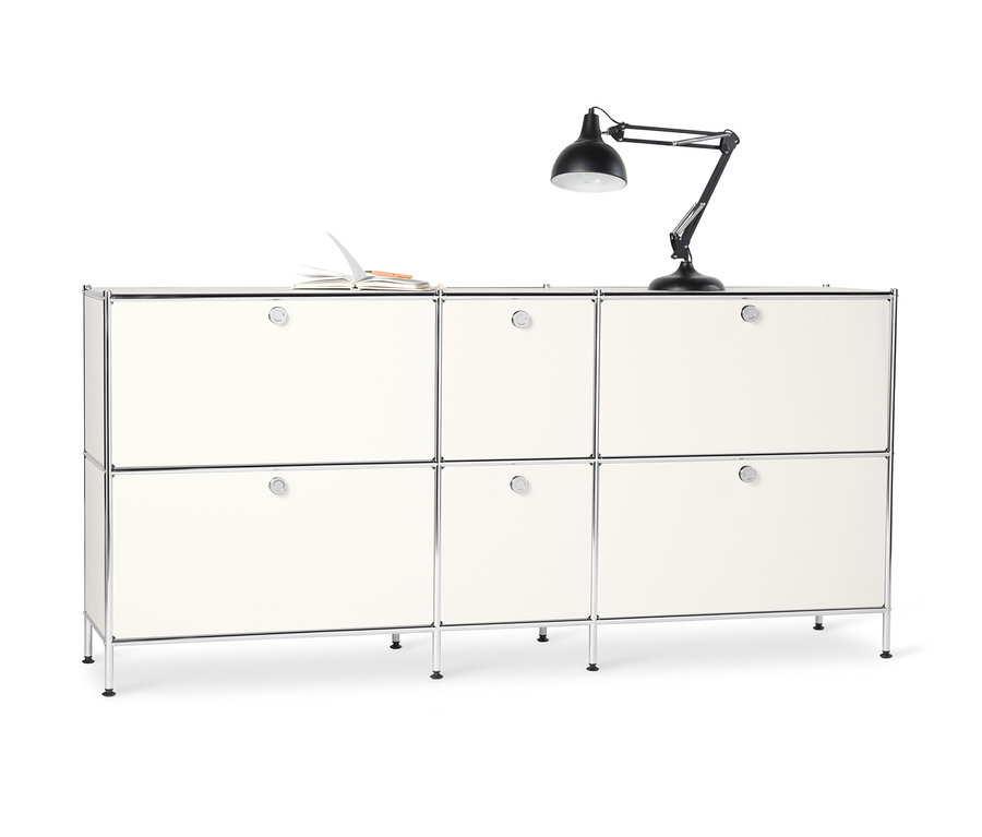 Grand buffet en métal « CN3 » blanc à 6 abattants. Un carnet ouvert et une lampe noire sont posés sur le dessus.