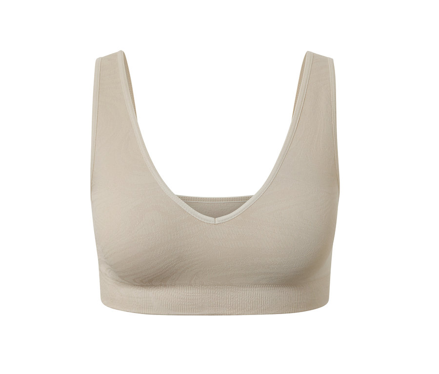 Une brassière de sport sans coutures de couleur beige.