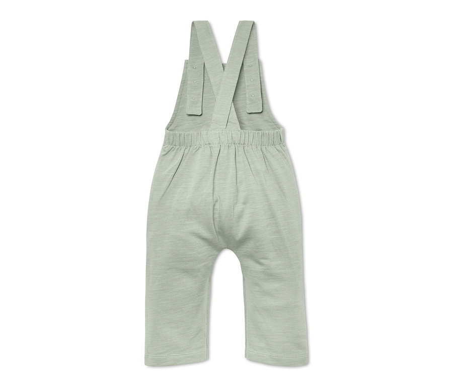 Salopette pour bébé vert clair sur fond blanc.