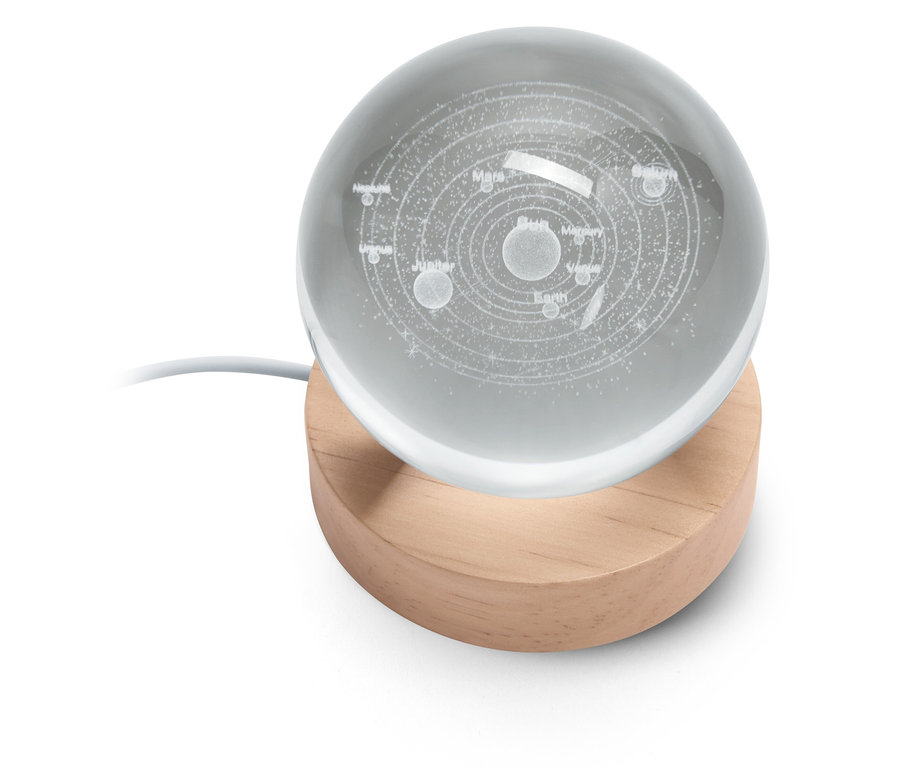 Boule en verre avec système solaire gravé sur un socle en bois.