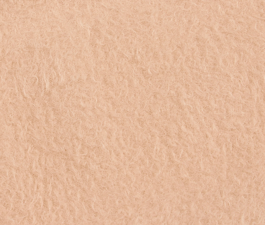 Gros plan sur une texture duveteuse couleur pêche.