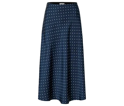 Jupe bleu marine à pois blancs, coupe évasée.