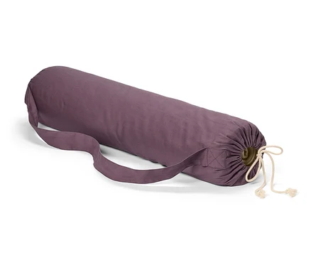 Sac de tapis de yoga violet avec cordon de serrage et bandoulière posé sur un fond blanc.