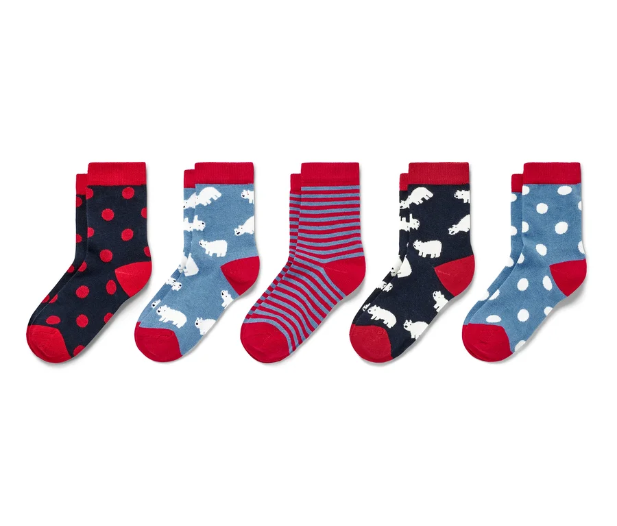Cinq paires de chaussettes pour enfant avec différents motifs, dont des pois, des rayures et des ours polaires.