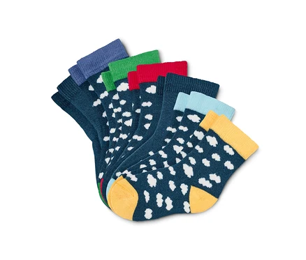 Sept paires de chaussettes pour bébé en coton bio avec des bords colorés et des points blancs.