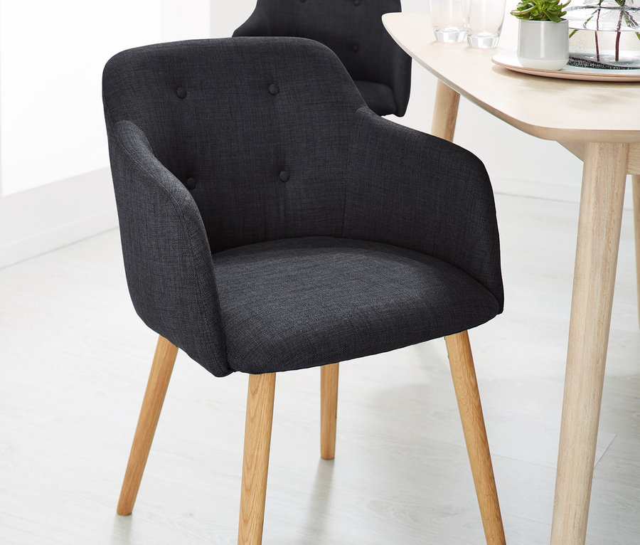 Deux chaises rembourrées anthracite près d'une table.