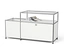 Système de rangement modulaire blanc avec cadre chromé et étagères en verre, un magazine roulé est posé sur l'étagère supérieure.
