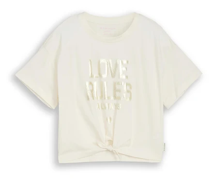 Un t-shirt crème avec l'inscription « Love Rules Always » et un nœud sur le devant.