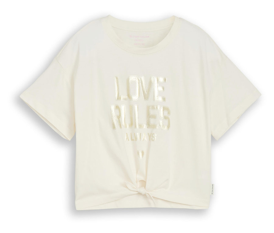 Un t-shirt crème avec l'inscription « Love Rules Always » et un nœud sur le devant.