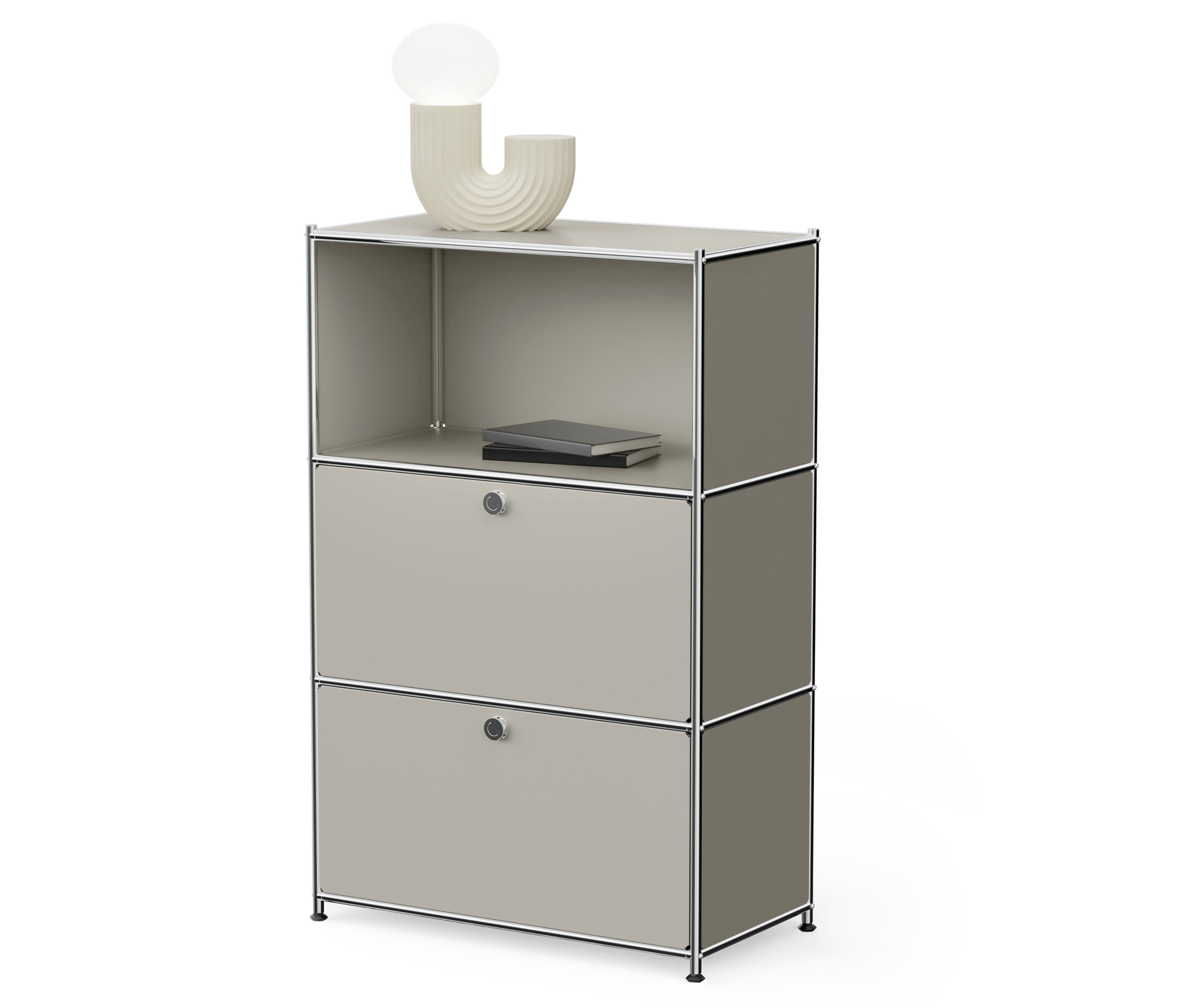 Armoire modulaire grise avec deux tiroirs et une étagère ouverte sur le dessus, sur laquelle repose un livre et une lampe.