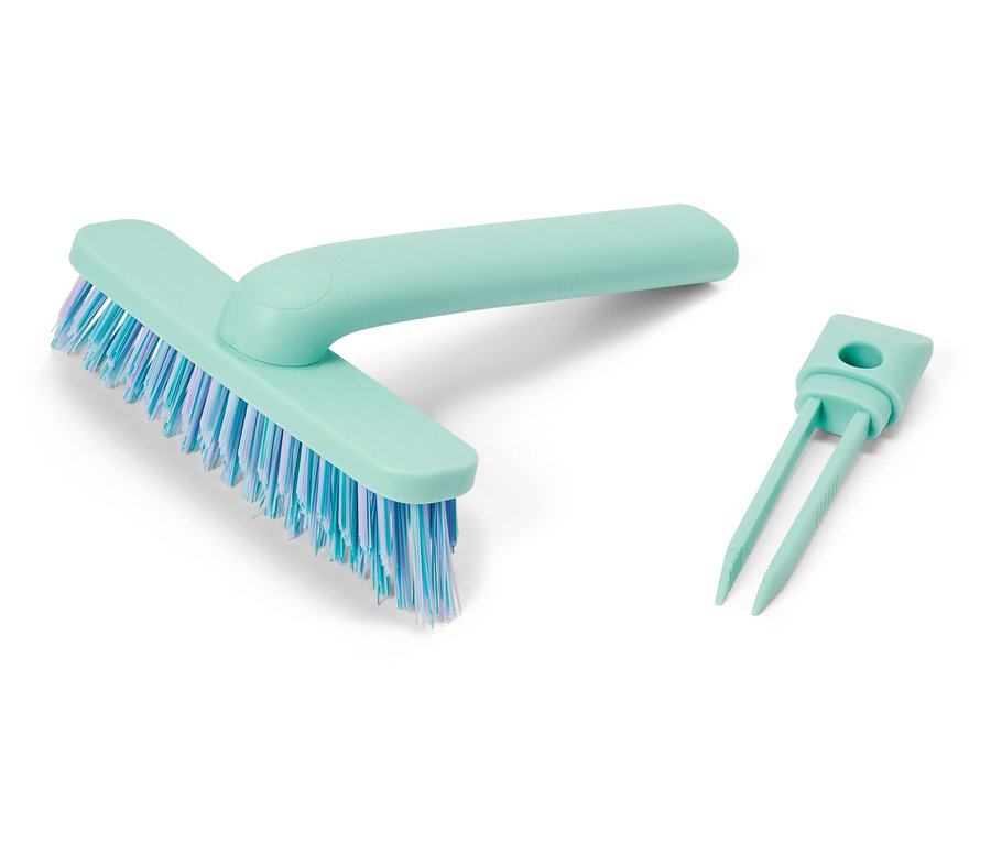 Brosse bleu clair avec des poils bleus et blancs et un outil de nettoyage des poils bleu clair.