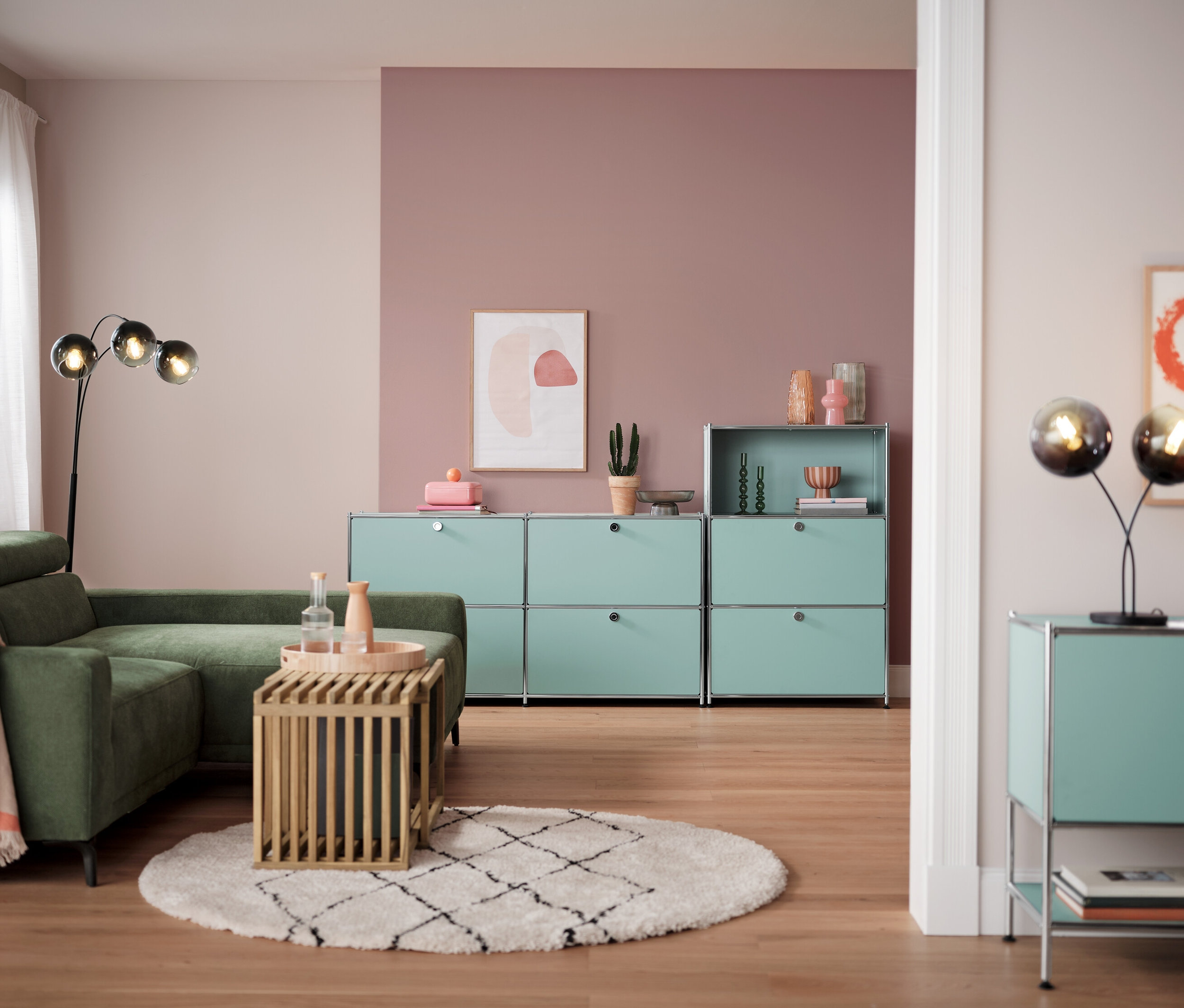 Salon avec canapé d'angle, table en bois et lampadaire arqué avec abat-jour en verre fumé.