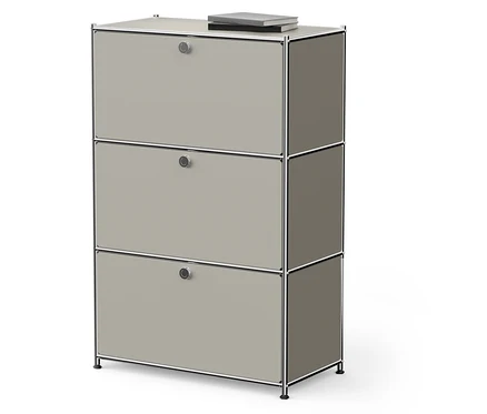Une armoire beige à trois étages avec un livre sur le dessus.