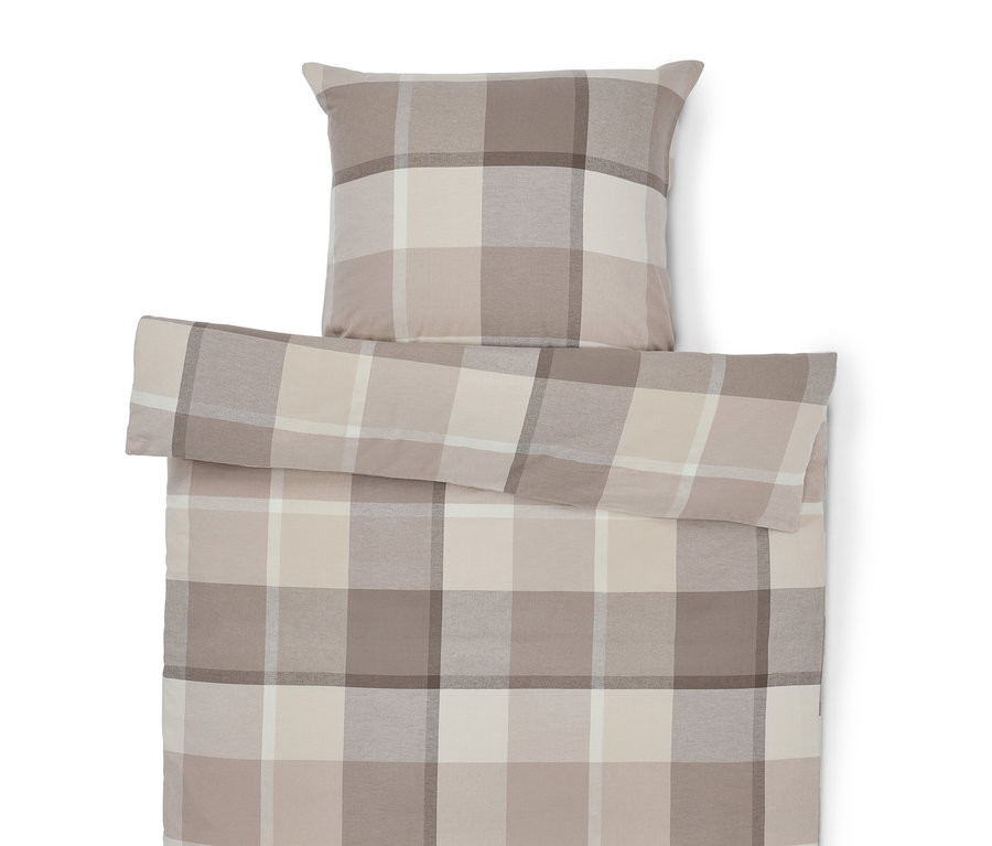 Housse de couette et oreiller à carreaux dans les tons beige.